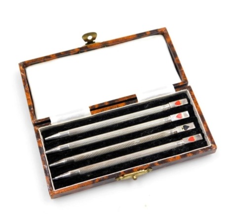 A set of four silver Bridge pencils, marked with the card suits, stamped sterling, cased.