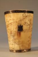 A 19thC scrimshaw horn beaker decorated with hunting scenes of fox hunting with hounds