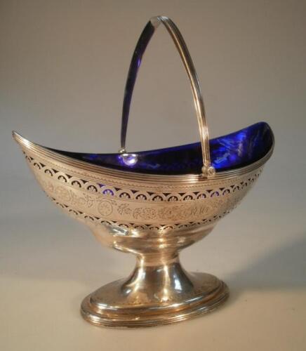 A George III silver sugar basket of boat-shaped form engraved with the initials R.M