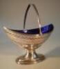 A George III silver sugar basket of boat-shaped form engraved with the initials R.M