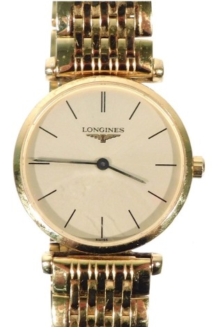 A Longines La Grande Classique lady's gold plated wristwatch, with a circular champagne dial, quartz movement, L4 209 2, serial number 30665670, on a bracelet strap.