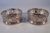 A pair of mid Victorian pierced and waisted silver wine coasters