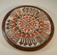 A Native American style circular beaded panel decorated in geometric design with cross