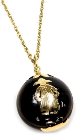 A lucite pendant, with yellow metal mounts, decorated to the front with a Dutch girl, on a neck chain, with bolt ring clasp.