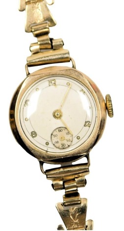 A mid century 9ct gold cased lady's wristwatch, circular silvered dial bearing Arabic numerals at evens, subsidiary seconds dial, the case of plain form, on a 9ct gold bracelet strap, 14.3g.