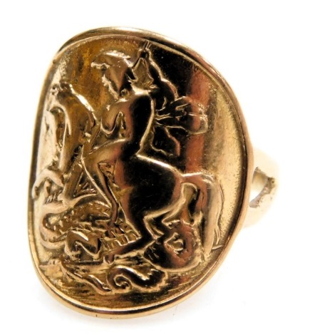 A 9ct gold ring, the curved table embossed with St George and The Dragon, size I, 3.5g.