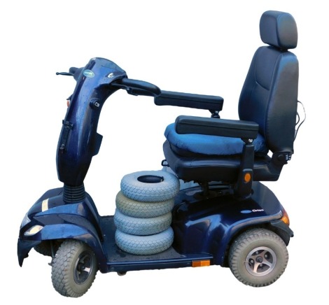 An Invacare Orion mobility scooter, in blue, with four spare tyres, seat pad, battery and key.