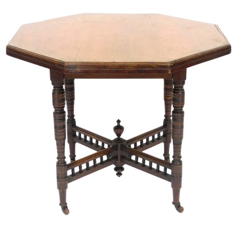 A Victorian mahogany octagonal window table, raised on turned legs united by a galleried X frame stretcher, capped on castors, 73cm high, 90cm wide.