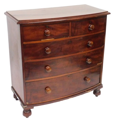 A Victorian mahogany bow front chest, of two short over three long graduated drawers, raised on turned feet, 111cm high, 108.5cm wide, 54.5cm deep.