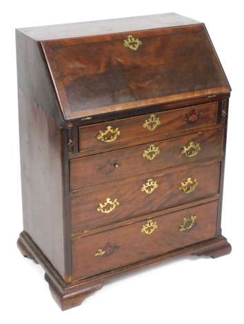 A George III mahogany and crossbanded bureau, stamped S.William & Sons Guildford, of small proportion, the fall flap opening to reveal a central door flanked by fluted semi secret column slides, four drawers and recesses, above four long graduated drawers