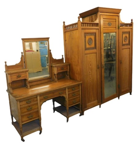 A late Victorian aesthetic movement light ash wardrobe compactum and dressing table by Shapland & Petter, the wardrobe having centre moulded cornice and gallery sides, the central fitted mirror door having press drawers over three solid and flanked by ros