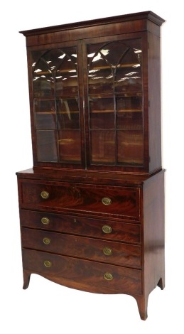 A George III mahogany secretaire bookcase, the upper section with a moulded cornice, raised above two arched astragal glazed doors revealing adjustable shelves above a secretaire and three long drawers, each with oval plate back handles on splayed legs, 2