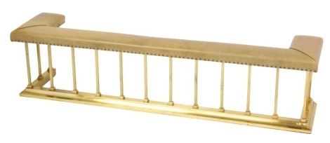 A Victorian style club fender, with leatherette top, raised on vertical brass bars with a plain D end base, 50cm high, 202cm wide, 47cm deep.