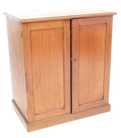 A Victorian mahogany cupboard, with plain rectangular top, and two cupboard doors, on a plinth base, 73cm high, 66cm wide, 42cm deep.