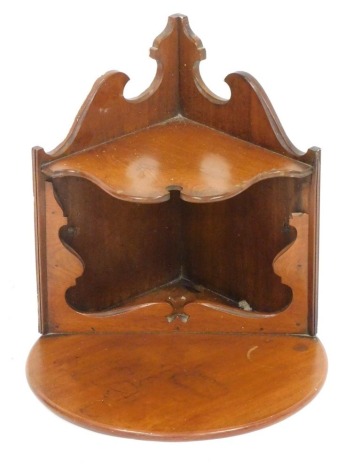 An early 20thC mahogany hanging corner shelf, with semi circular top, above shaped under section, with carved sides on a moulded base, 36cm high, 36cm wide, 36cm deep. (AF)