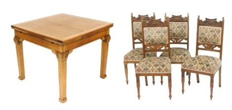 An early 20thC light oak draw leaf dining table, raised on foliate carved capped square legs, 76cm high, 91cm wide,152cm extended, 91cm deep, together with four Victorian oak single dining chairs, upholstered in floral patterned overstuffed fabric, raised