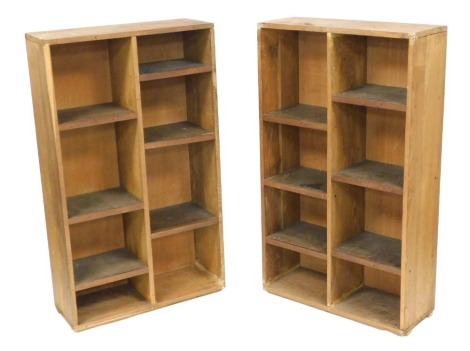 A pair of mid-century oak free standing shelves, of rectangular section, with six staggered shelves 128cm high, 75cm wide, 28.5cm deep.