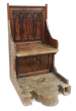 A stained pine Gothic style throne chair, the two seat back with carved detailing, on a later base, 153cm high, 83cm wide, 110cm deep. (AF)