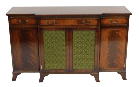 A Georgian reproduction mahogany break front sideboard, with one long fitted and two short drawers, above a pair of fabric backed central doors, flanked by two further doors, raised on bracket feet, 92cm high, 153cm wide, 45.5cm deep.