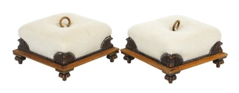 A pair of late Regency mahogany footstools, with later upholstered oatmeal coloured fabric, raised on fluted feet, 37cm wide.