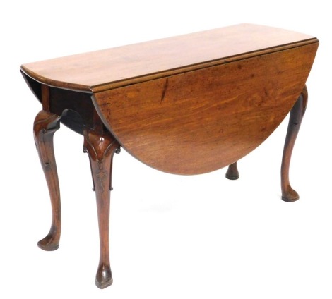 A George III mahogany drop leaf dining table, raised on carved cabriole legs, on hoof feet, 72cm h, 122cm w, 41cm d, 116cm extended.