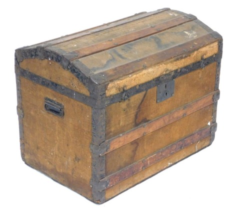 A Victorian canvas bound wooden trunk, with wooden and iron strapwork, hinged lid opening to reveal a tray top and vacant interior, with cast iron carrying handles, 54cm high, 69cm wide, 46cm deep.