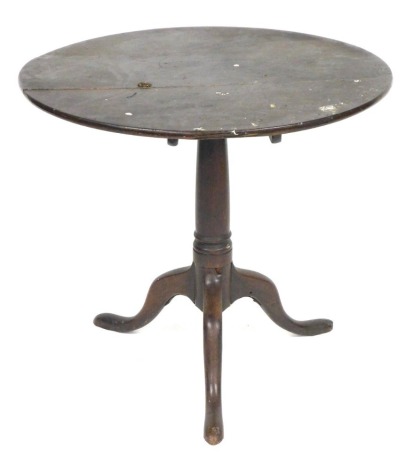 A George III oak tilt top occasional table, raised on a turned column over three cabriole legs, 70cm high, 76cm deep.