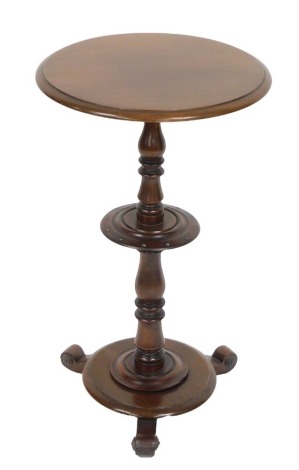 A Victorian mahogany occasional table, raised on a baluster turned column, above a circular base and three scroll feet, 70cm high, 40.5cm diameter.