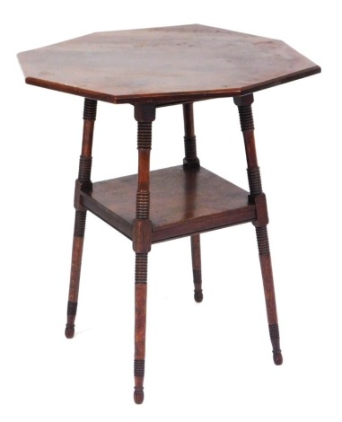 A Victorian oak octagonal occasional table, raised on ring turned supports united by a square under tier, 70cm high, 59cm wide.