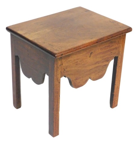 A George III mahogany stool, formerly a commode, with a hinged lid, and shaped apron, raised on square legs, 48cm wide.