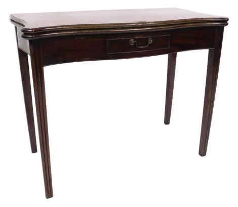 A George III mahogany tea table, with serpentine plum pudding folding top, having thumb nail border and with a small drawer with brass swan neck handle to the plain frieze, raised upon triple fluted square tapered legs, 72cm high, 92cm square..