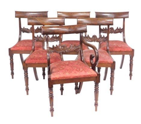 A set of six Regency mahogany bar back dining chairs, with drop in seats, raised on turned and lappet carved legs, comprising a carver and five single chairs.