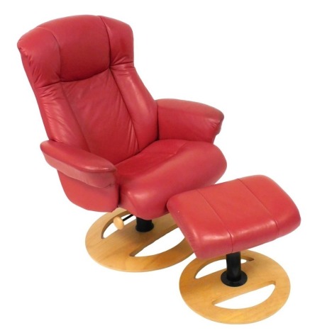 A Stressless red leather and ash swivel armchair, and matching footstool, armchair 79cm wide. (2)