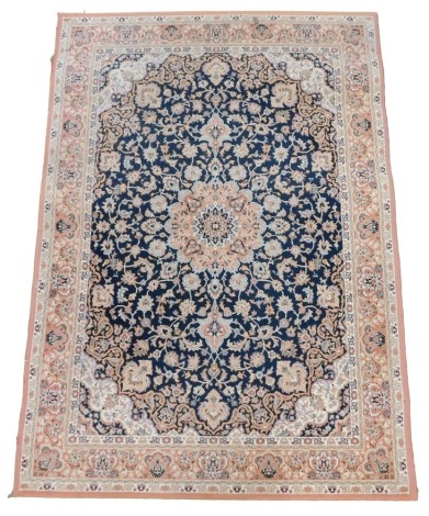 A Belgian style blue ground rug, decorated with floral and foliate motifs, within repeating floral borders, 200cm x 141cm.