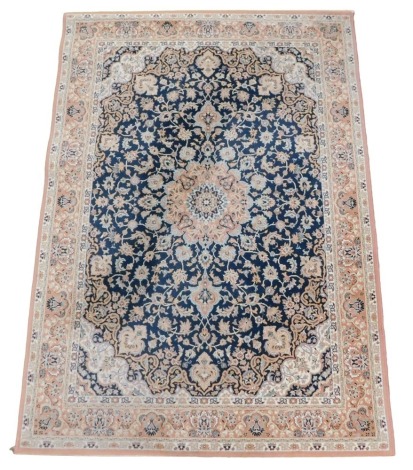 A Belgian style blue ground rug, decorated with floral and foliate motifs, with in repeating floral borders, 200cm x 141cm.