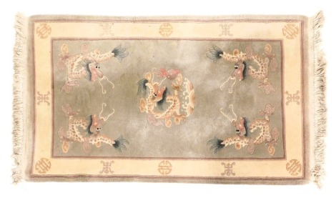 A Chinese grey ground rug, decorated with dragons chasing flaming pearls, within a cream border, 158cm x 92cm.