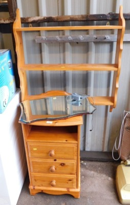 A pine wall shelf, pine bedside cabinet and a wall mirror.