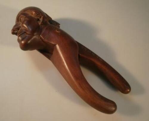 A late 19thC/early 20thC novelty treen nut cracker