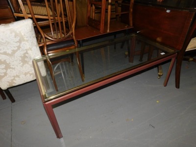 A brass and glass rectangular coffee table. This lot is located at our additional premises SALEROOM SIX, Unit 6, Ellesmere Business Park, Grantham, NG31 7XT. All collections for this section must be done Friday 9th February 2024 & Monday 12th February 2