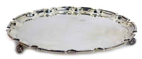 A George V silver salver, with piecrust border, raised on three scrolling feet, William Hutton and Sons Ltd, Sheffield 1929, 30.37oz, 30cm diameter.