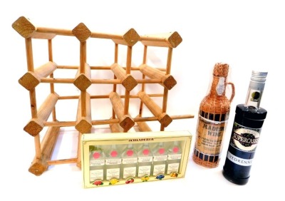 A bottle of Creme Cassis, together with a bottle of Madeira Wine, in original packaging with basket cover, and six miniature bottles of Schladerer Schnapps, and a wine rack. (9)