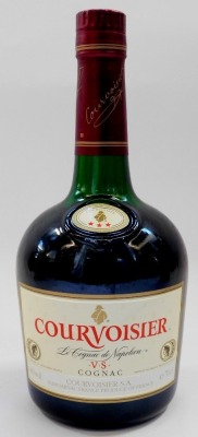 A bottle of Chateau De Laubade V.S.O.P. Armagnac, a small bottle of Janneau X.O. Armagnac, and a bottle of Courvoisier V.S. Cognac. (3) - 6