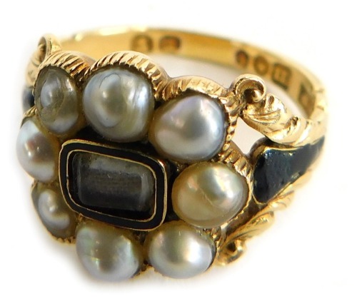 A George IV gold and pearl cluster memorial ring, with a central brass locket and surround of eight pearls, black enamelled shoulders, hallmarked for London 1827 and inscribed ? Atkinson 16th May 1827 ...., ring size L 1/2, with ring box.