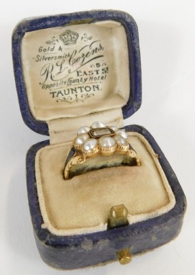 A George IV gold and pearl cluster memorial ring, with a central brass locket and surround of eight pearls, black enamelled shoulders, hallmarked for London 1827 and inscribed ? Atkinson 16th May 1827 ...., ring size L 1/2, with ring box. - 4