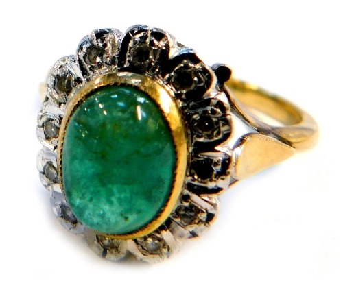 A cabochon emerald and diamond dress ring, on a yellow metal shank stamped 18ct, size P, 5.8g all in.