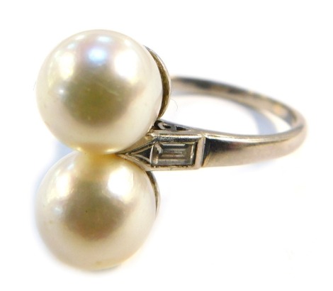 A double cultured pearl set dress ring, with baguette cut diamond shoulders, on a white metal shank stamped 18ct, size O, 5.7g all in.