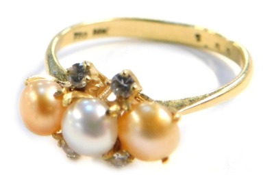 A pearl and diamond dress ring, with three bi-colour pearls, in a yellow metal shank stamped 750 & 18k, size O, 2.7g all in.