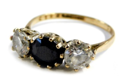 A 9ct gold three stone dress ring, set with a central round brilliant cut sapphire, flanked by two CZ stones, size S, 3.2g all in.