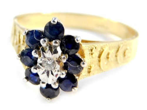 An 18ct gold diamond and sapphire flower head ring, with engraved shoulders, size T, 5g all in.