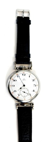 An early 20thC Omega pocket watch wristwatch, open faced, keyless wind, circular enamel dial bearing Arabic numerals, subsidiary seconds dial, the case engraved MI 5549, on a leather strap.